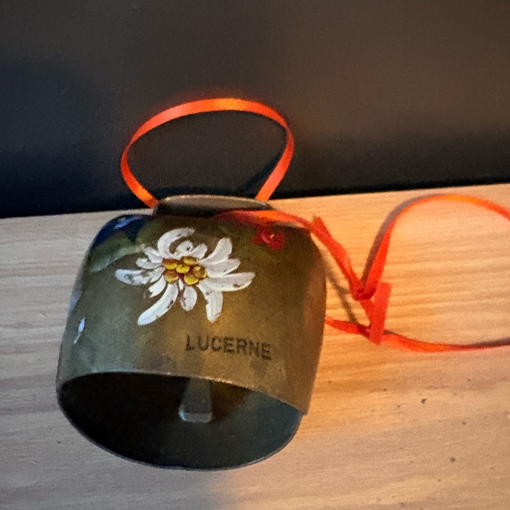 Brass Cowbell with White Floral Accent and Red Ribbon